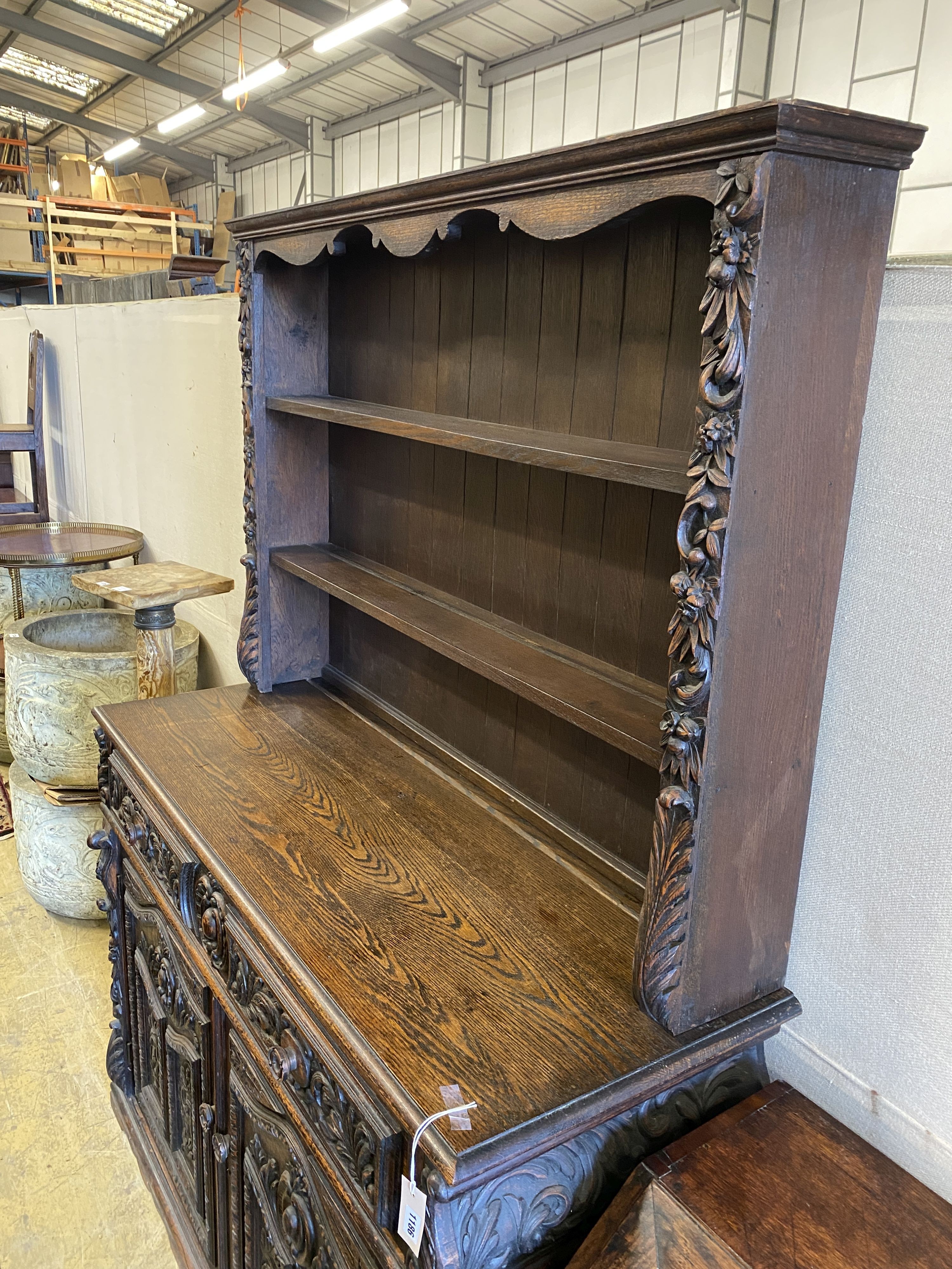 A late 19th century Flemish carved oak dresser, length 135cm, depth 50cm, height 192cm